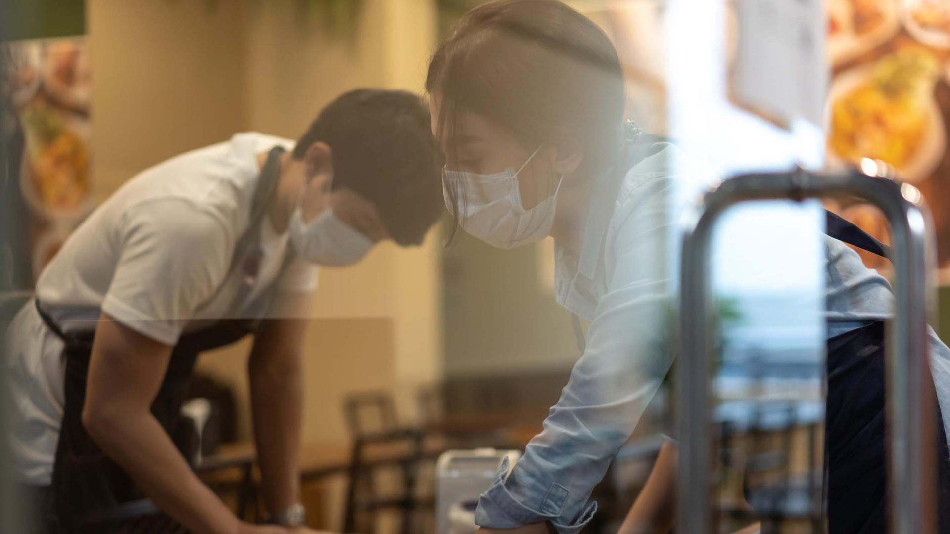 Cafe cleaners wearing masks